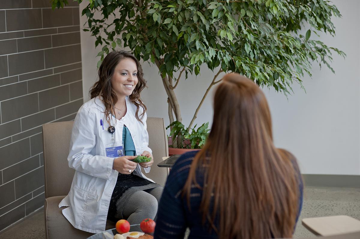 Nutrition dietetic practitioner smiling and talking with a client