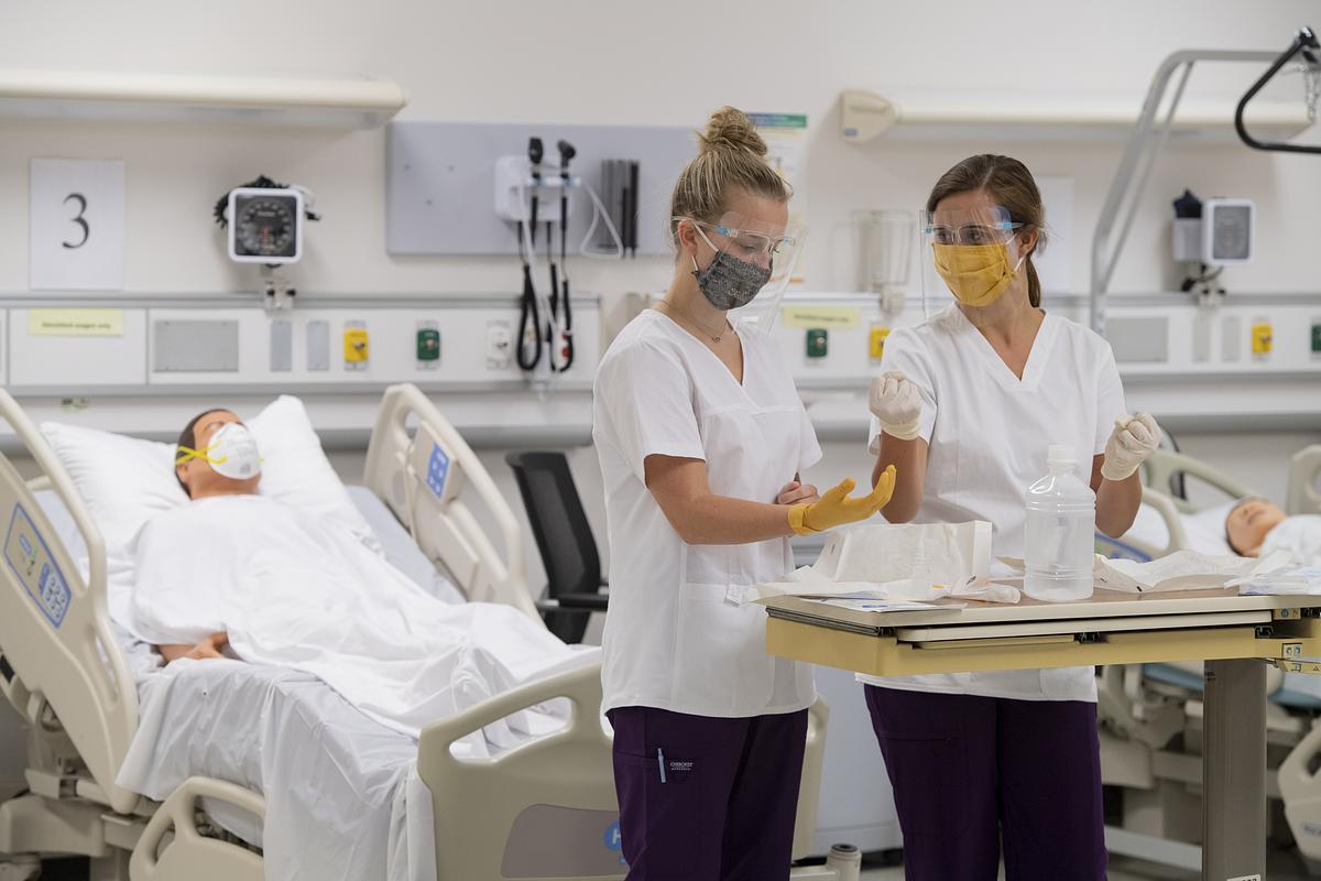 Two nurse practitioners working together in a lab setting