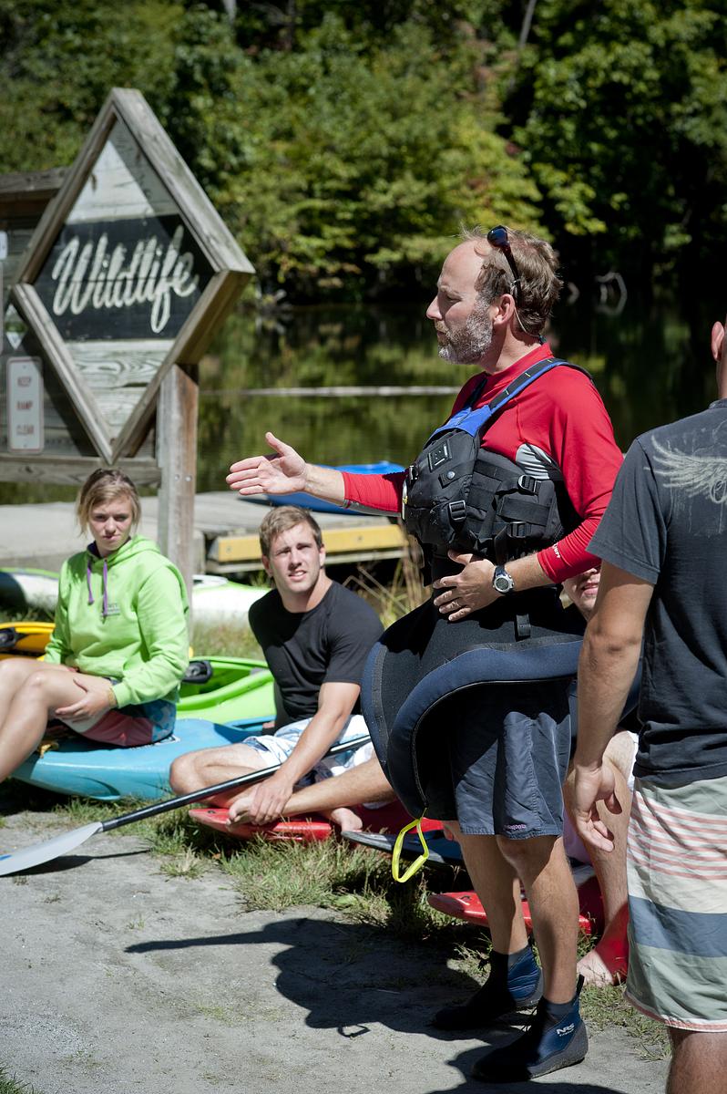 Instructor showing students a proper safety and paddling technique