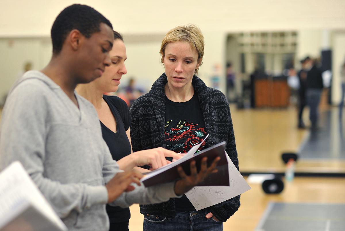 Teacher and students looking at pamphlets