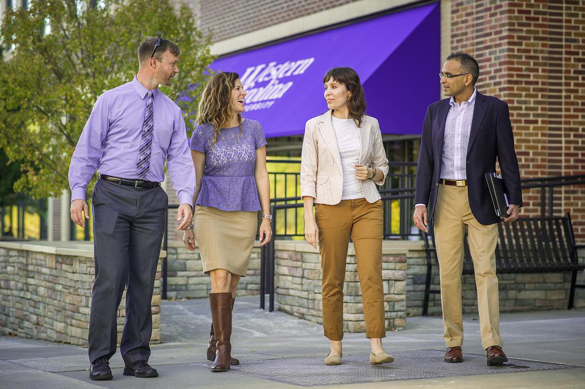 Graduate students walking along the sidewalk outside of the WCU Asheville location