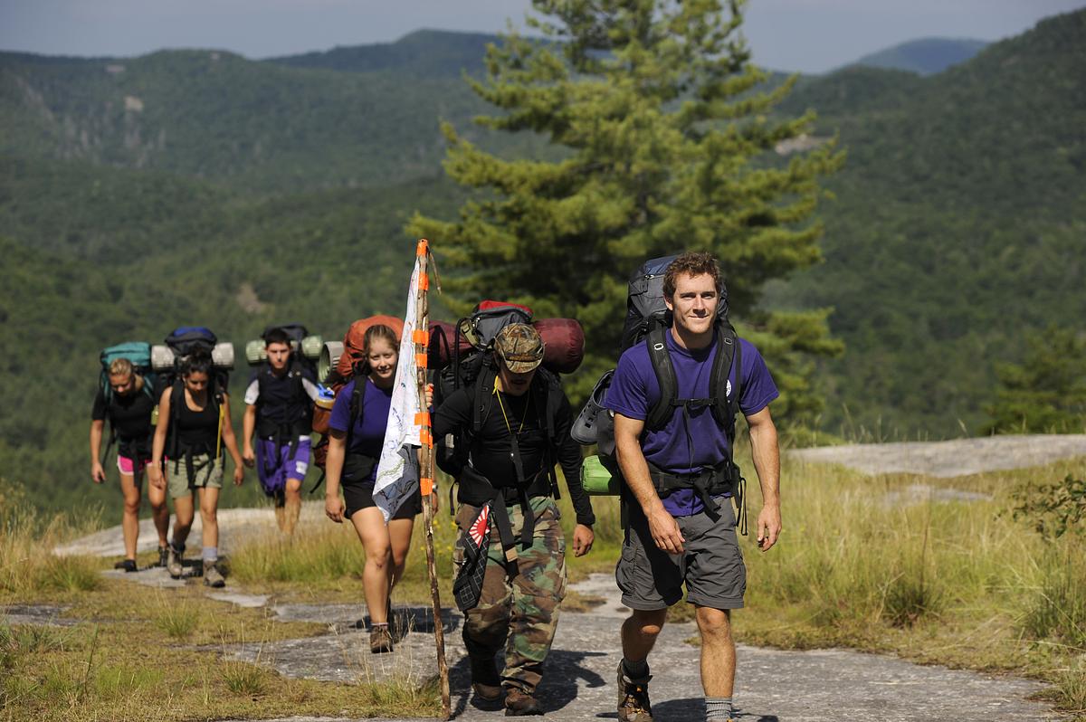Students hiking up a mountain in panther town valley