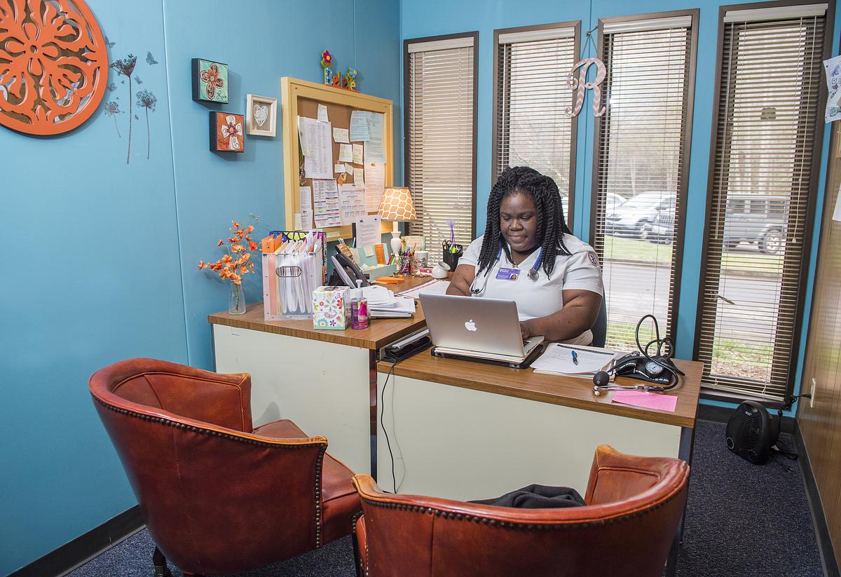 Nursing student on their laptop in an office