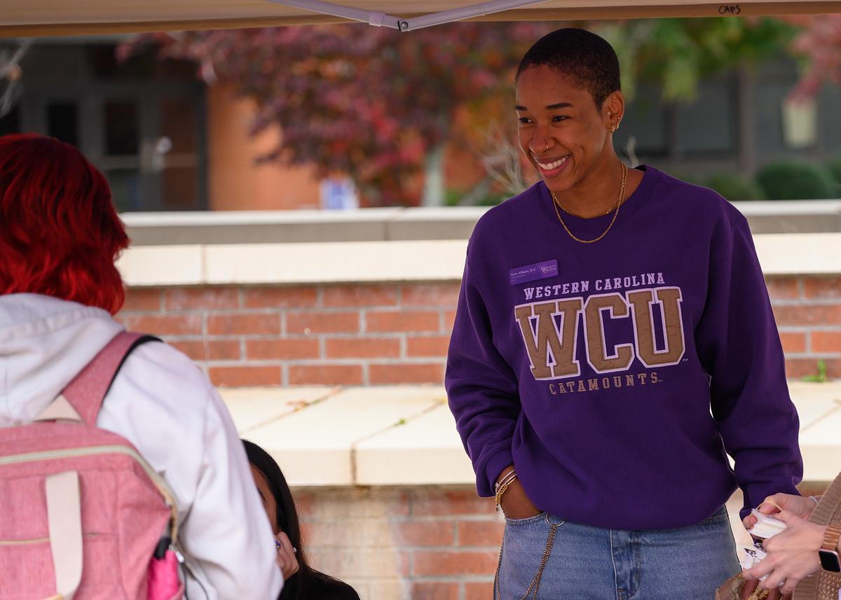 Student visiting a promotional table at an outdoor event