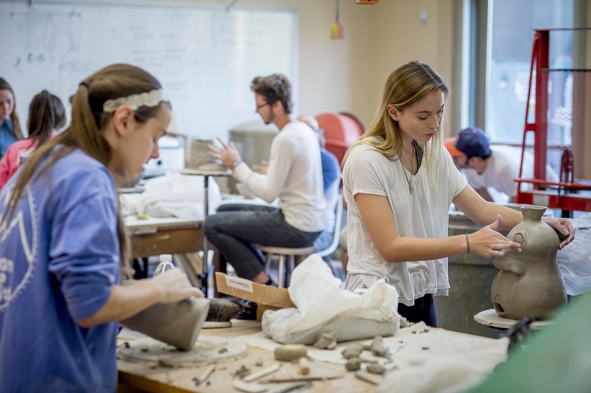 Students in the studio creating individual sculptures out of clay