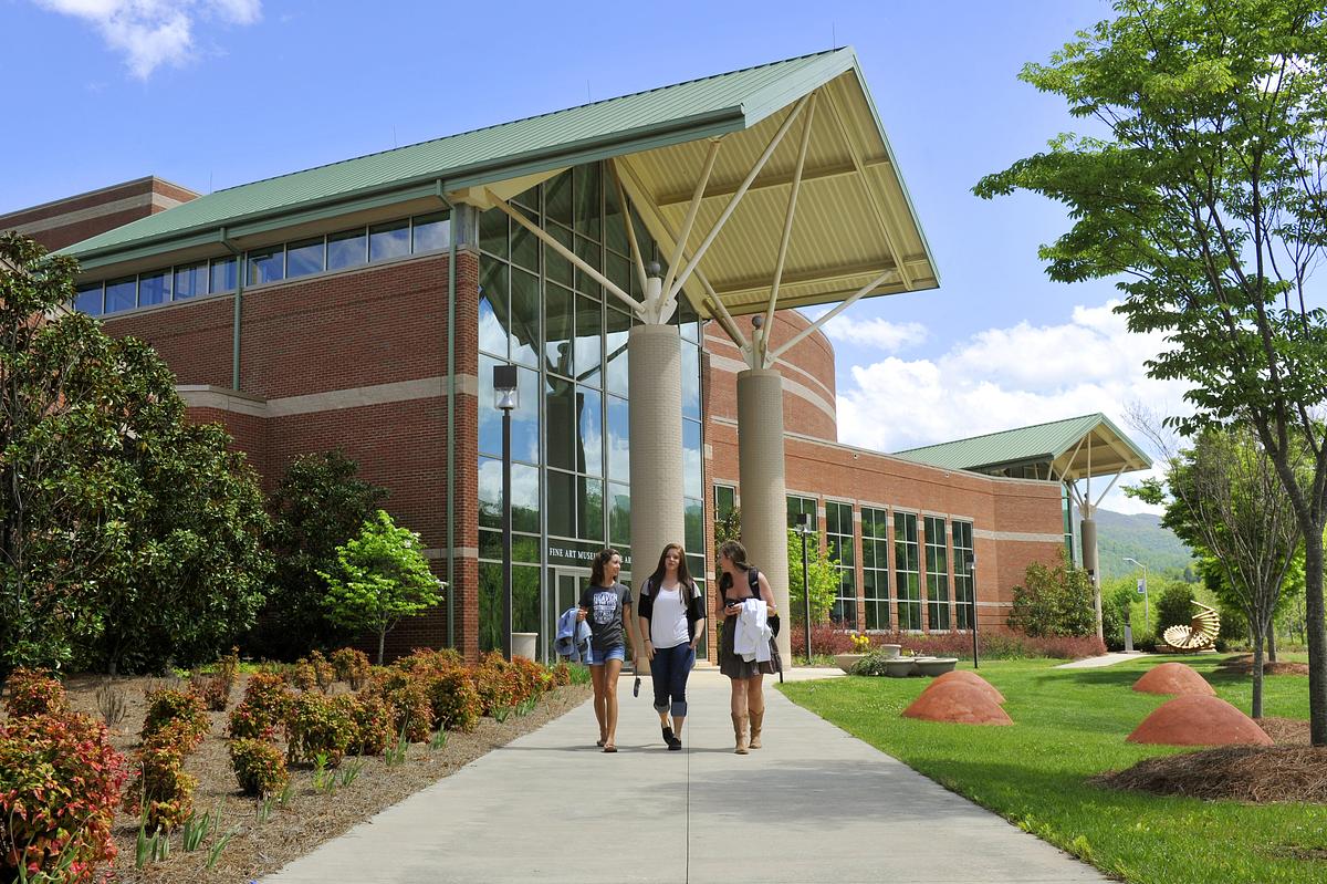 Front door of the Bardo Performing Arts building on a beautiful summer day with students walking toward the camera