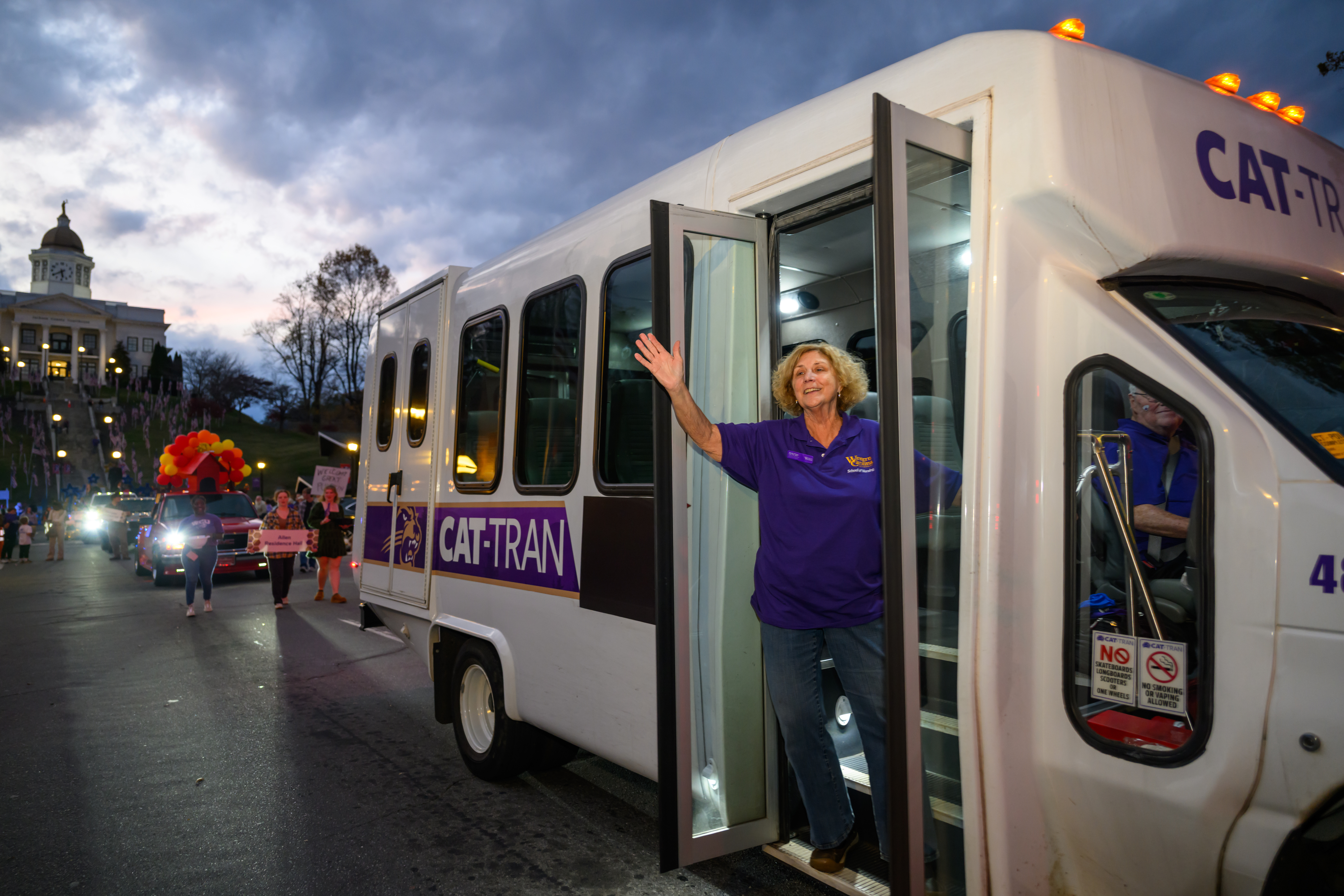 Cat-Tran driver waving in homecoming parade in Downtown Sylva