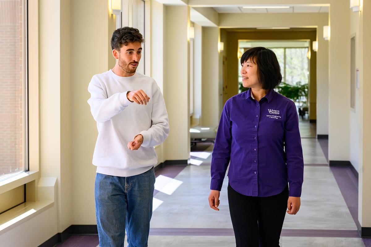 Student talks with a faculty member