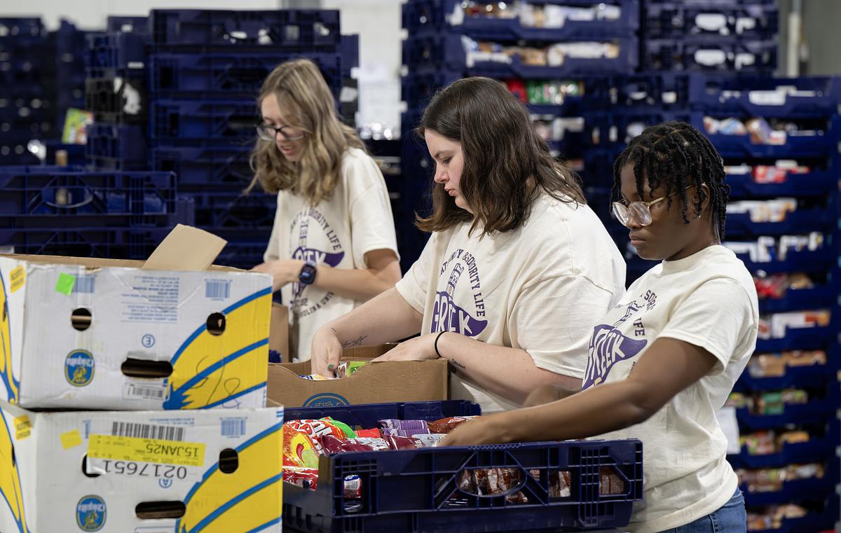 Students going through food boxes for donation