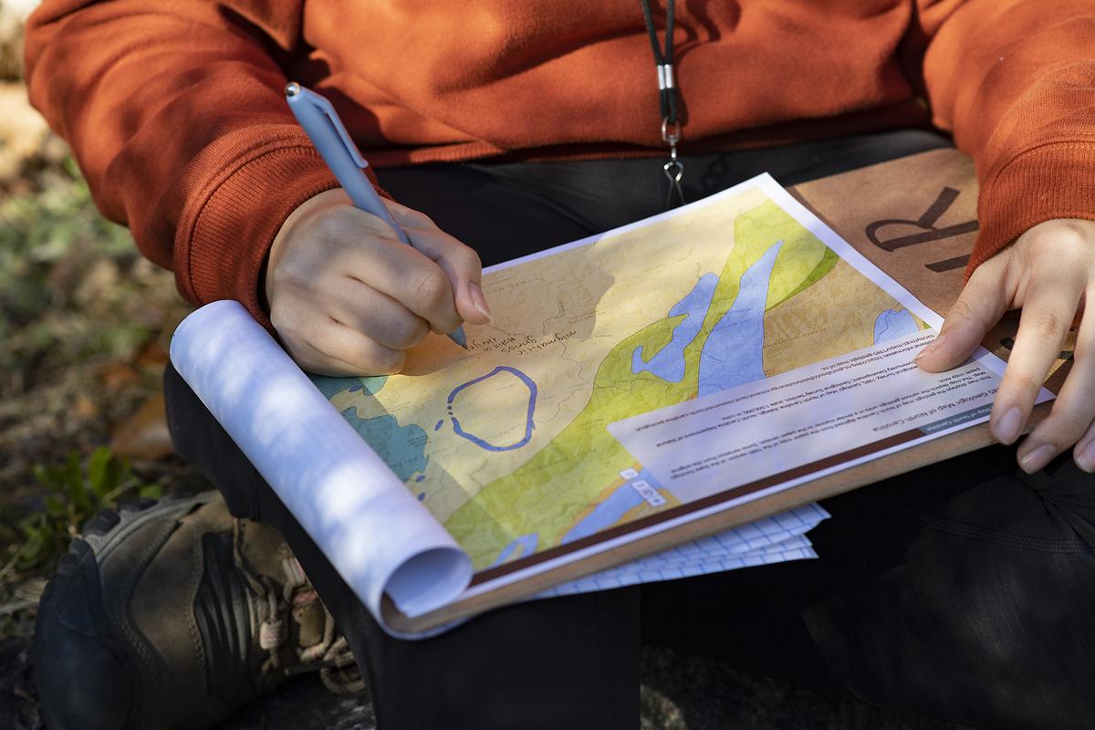 Student looking over a map with a circle over a specific region