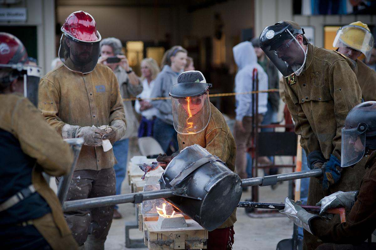 Students and teachers casting metal