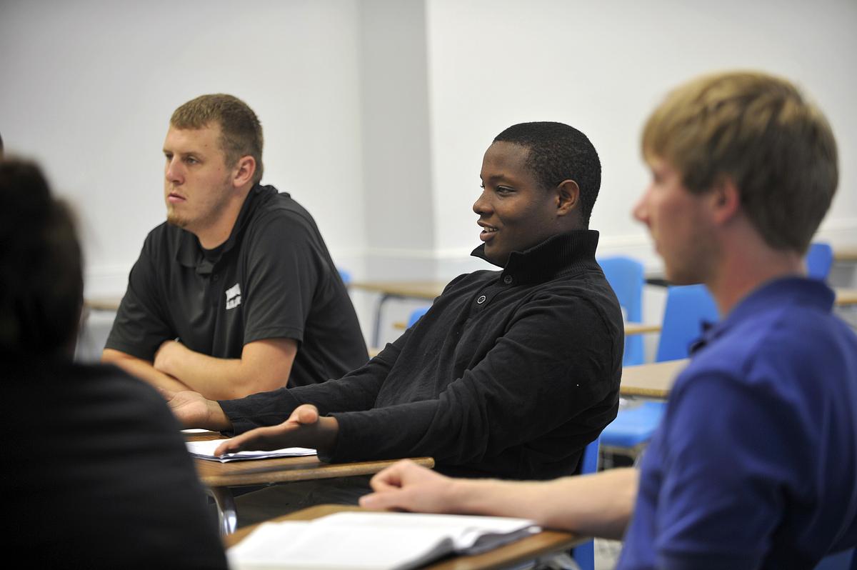 Sports management students sitting in a classroom in discussion