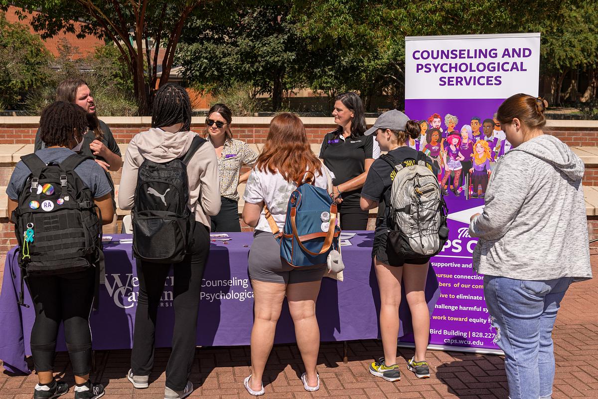 Students and staff at the Counseling and Psychological Services booth at the Health and Wellness Fair