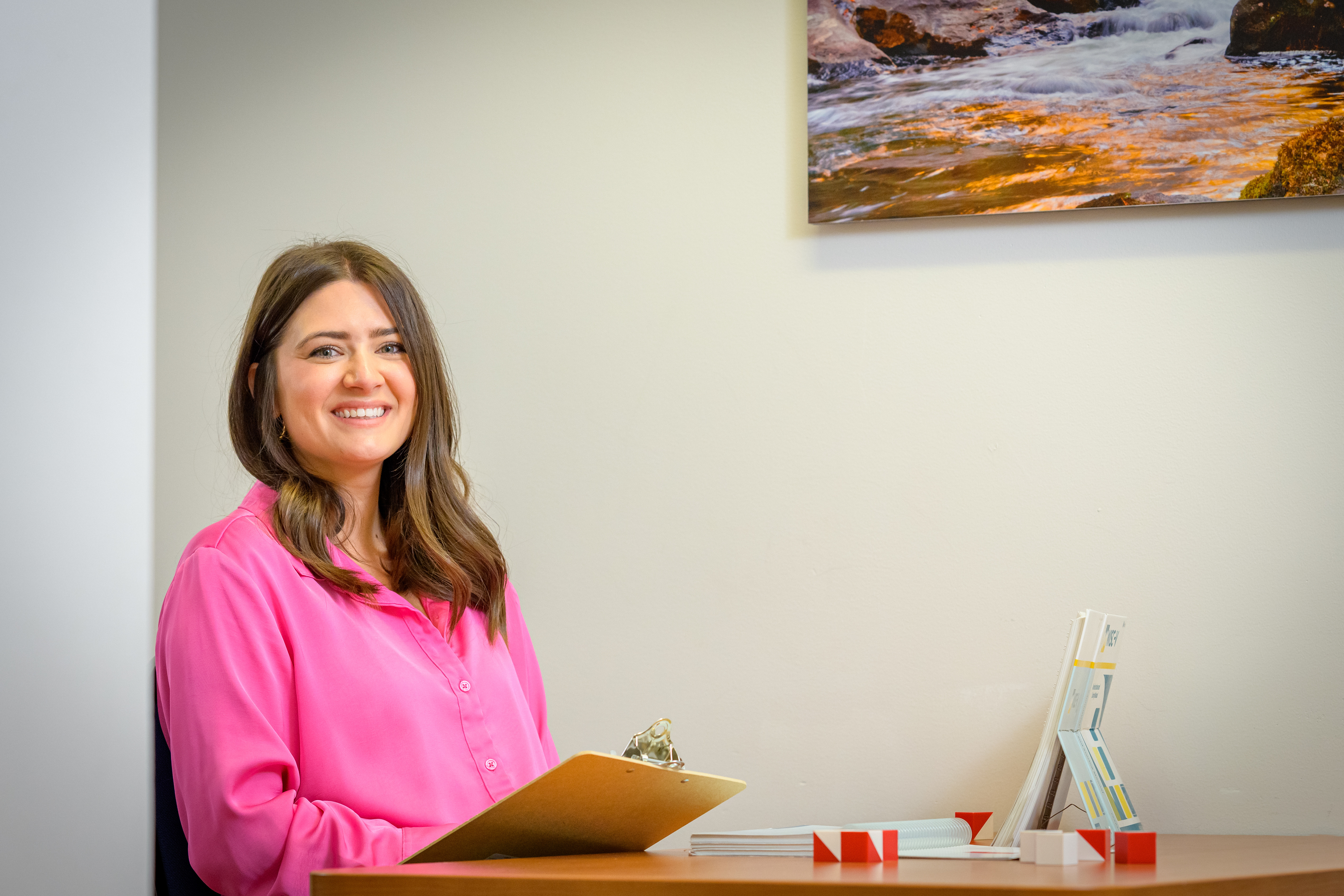 CEAP's Alyssa Raggio smiling for the camera at a desk