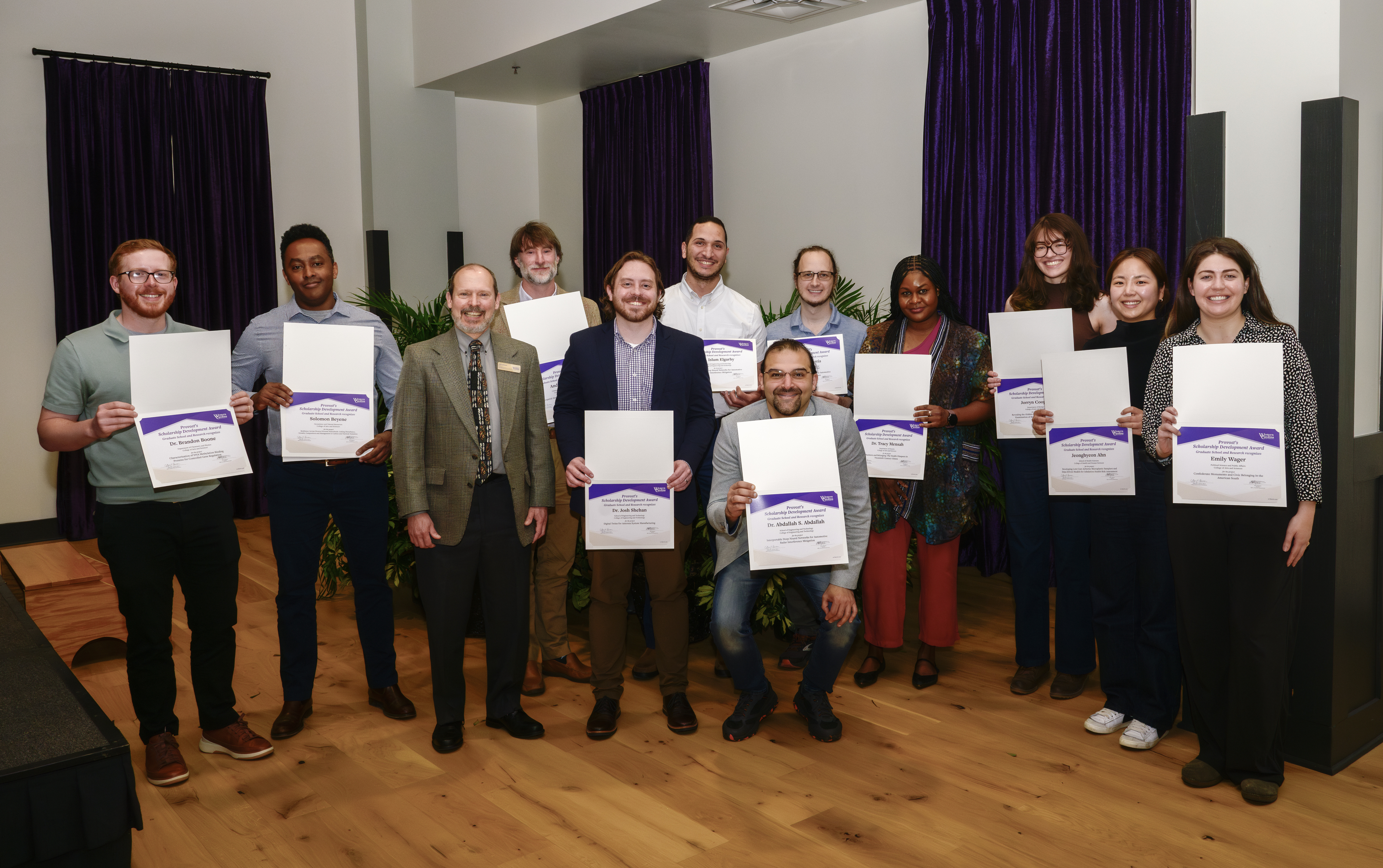 RASC faculty members stand and smile for a group photo
