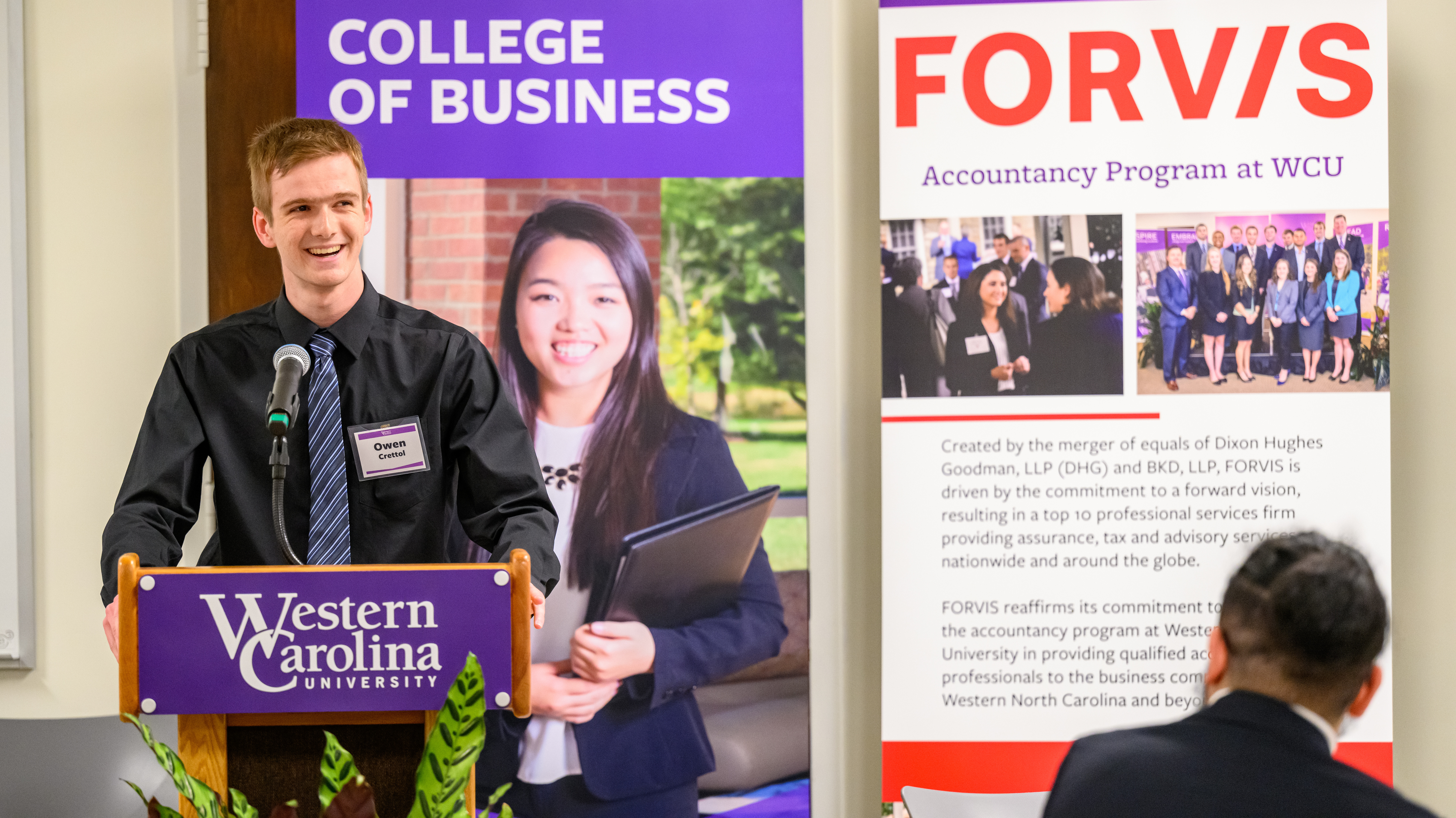 Business student speaking at a podium in front of an audience
