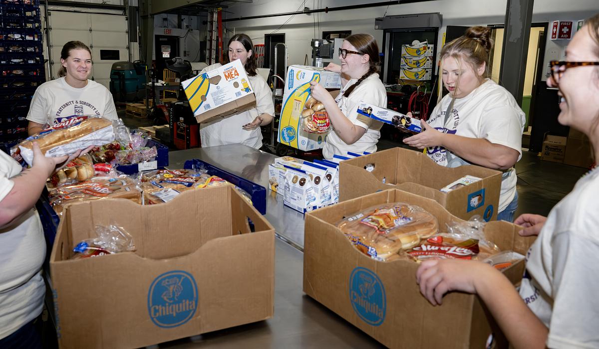 Students organizing food boxes and talking among each other