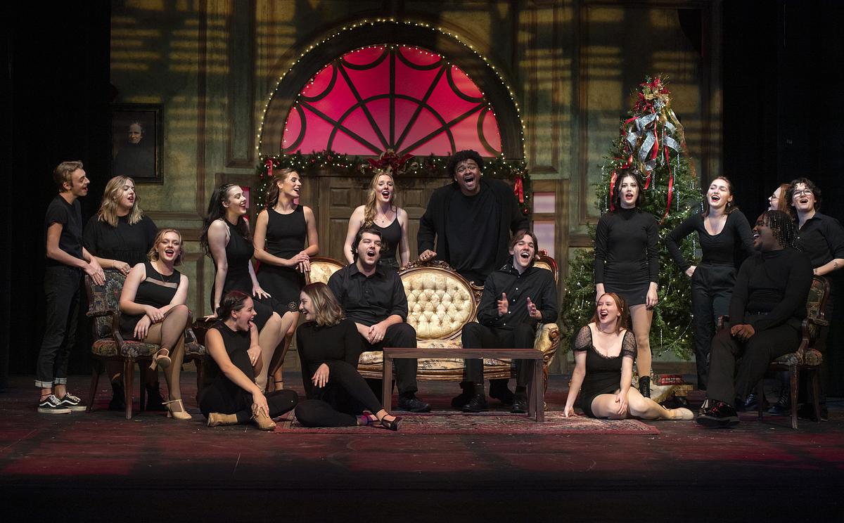 Students singing in a musical performance on stage