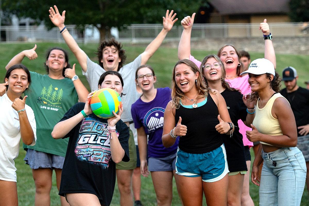 Group of students playing volleyball outside