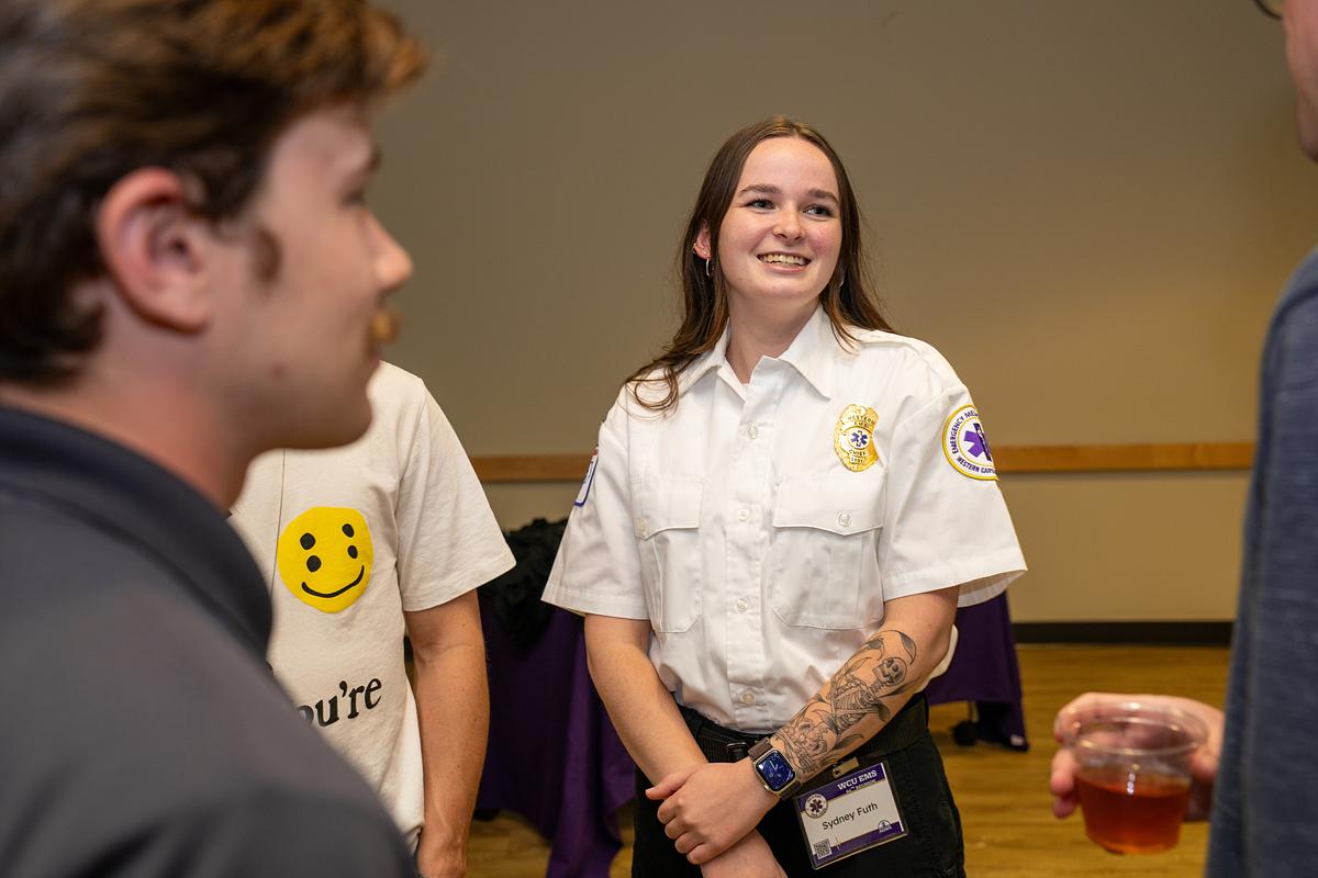 Student EMS staff talking at the 60th Anniversary Celebration