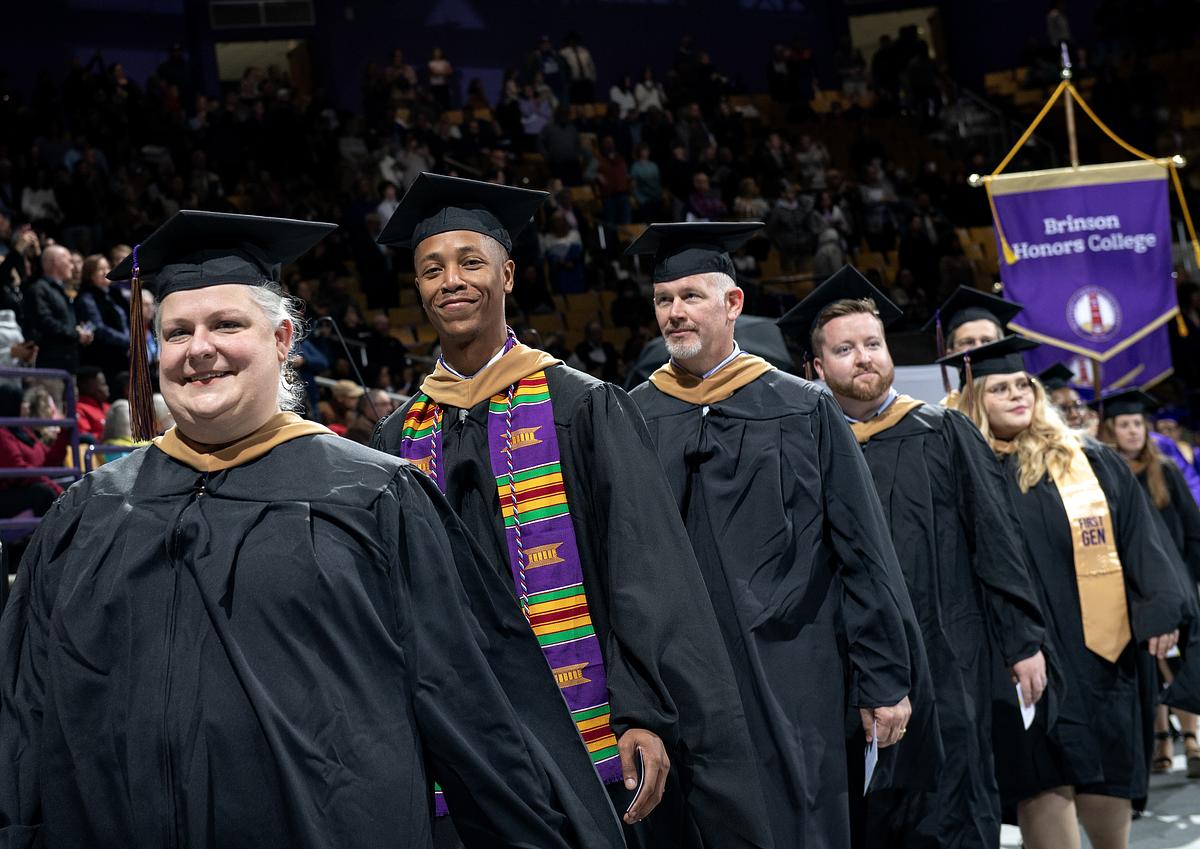 Brinson Honors College graduates walking down the isle at commencement