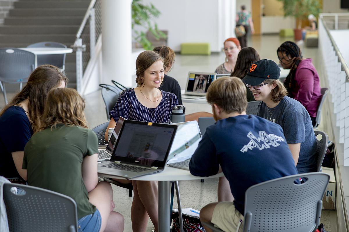   Social work students studying and talking at a desk together