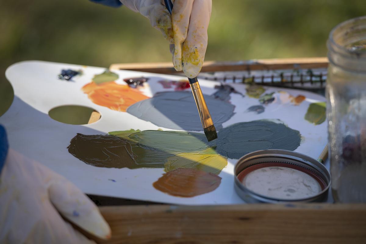 Student using paint brush on a pallet