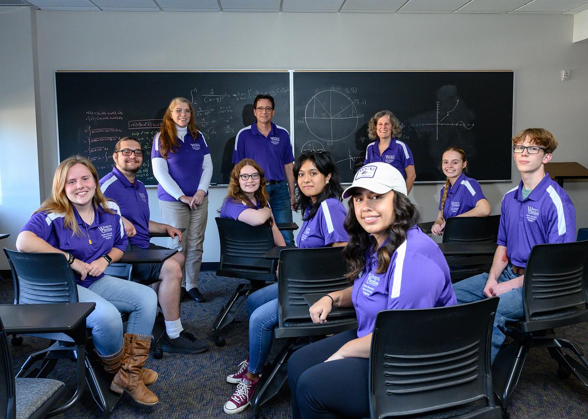 Noyce program members and staff gathered together for a group photo in a classroom