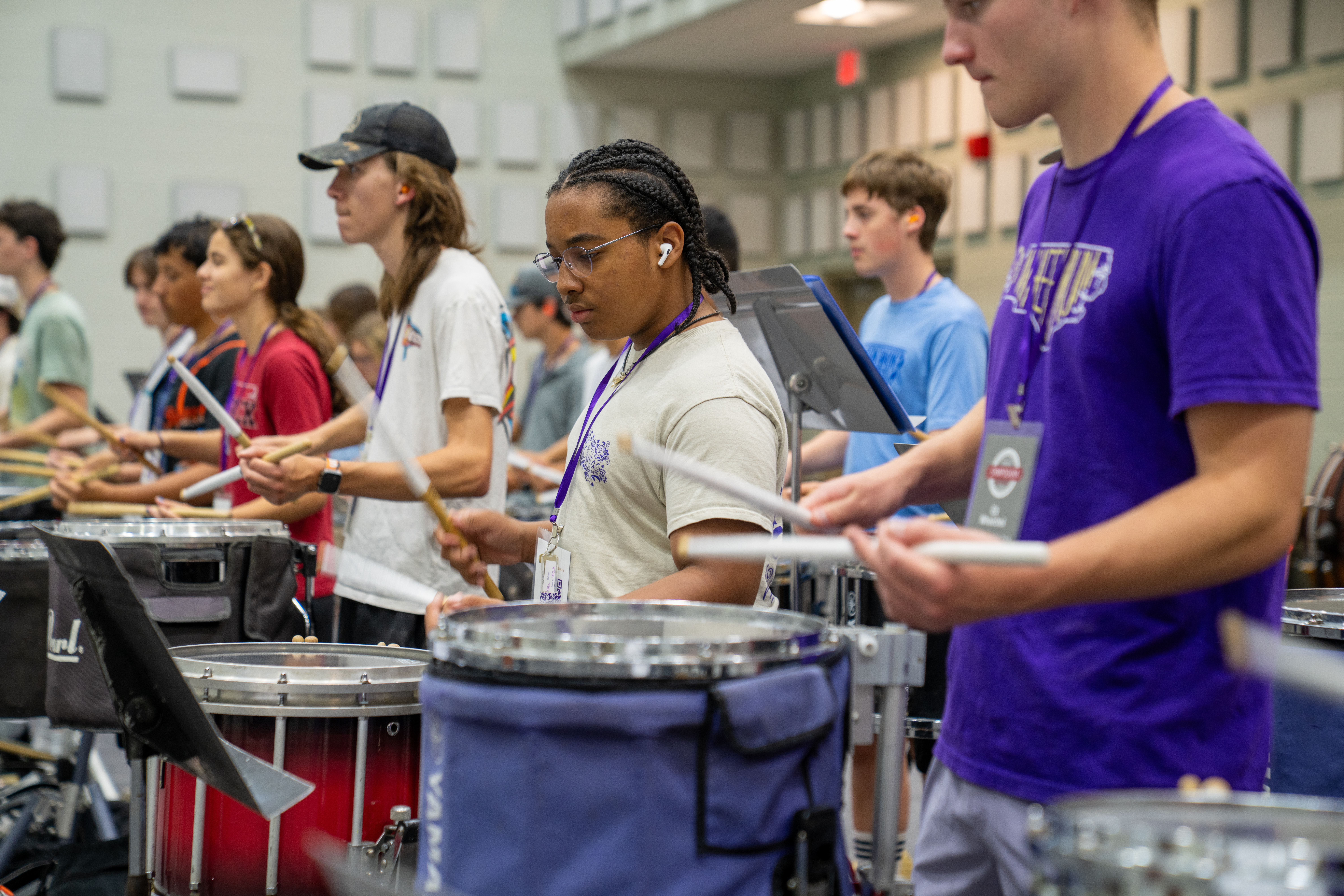 Vlog summer symposium participants play the drums