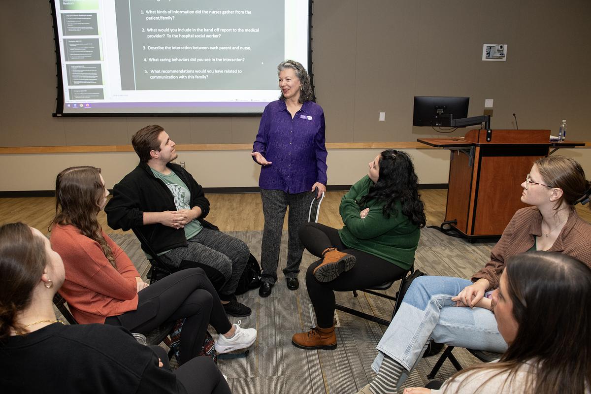 Students listening to a teacher speak