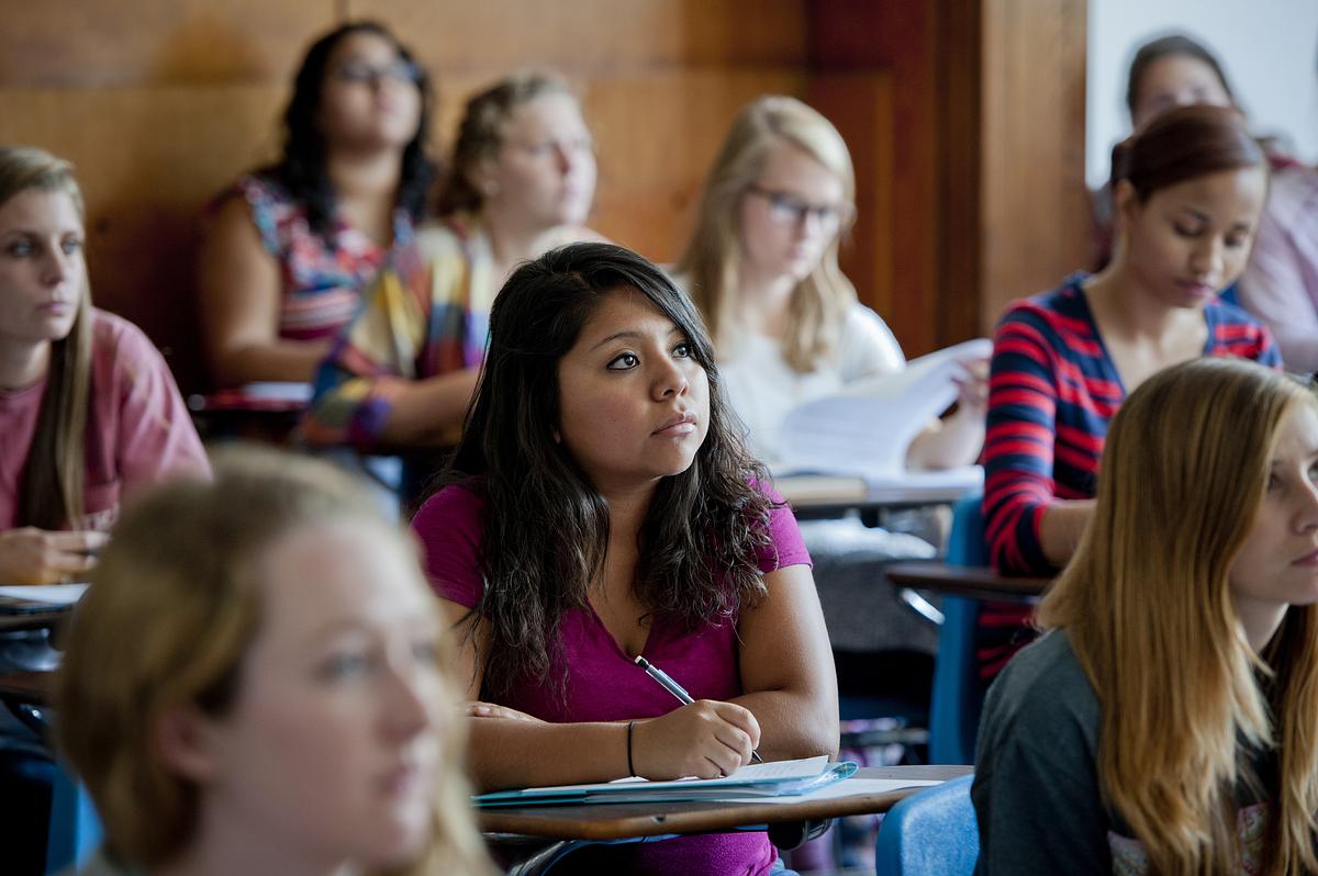Students listening and taking notes during a world languages class
