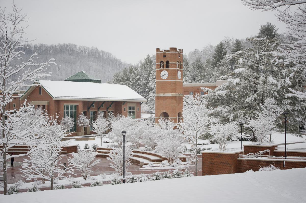 Alumni tower and campus buildings covered in snow