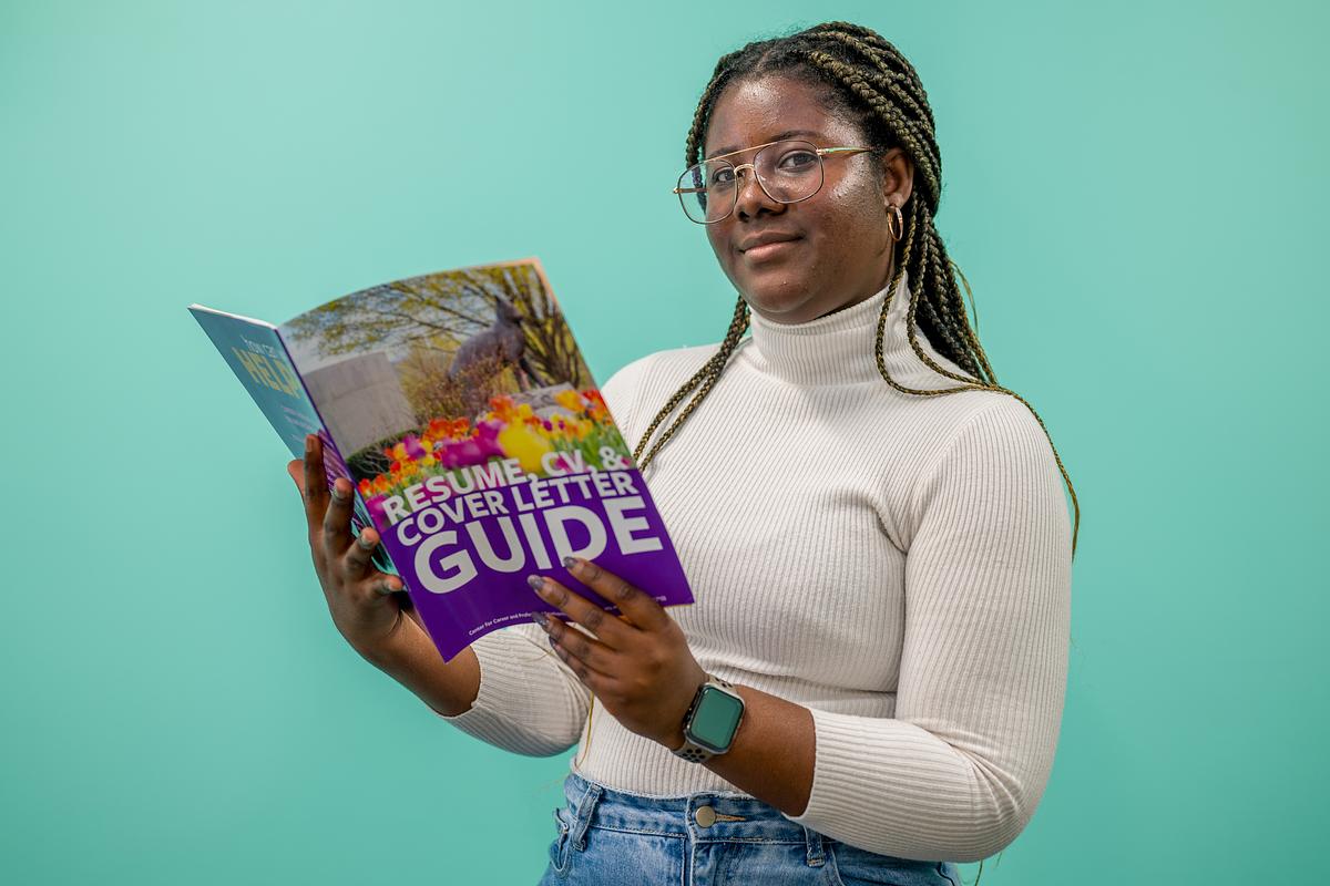 Young woman holding a resume booklet