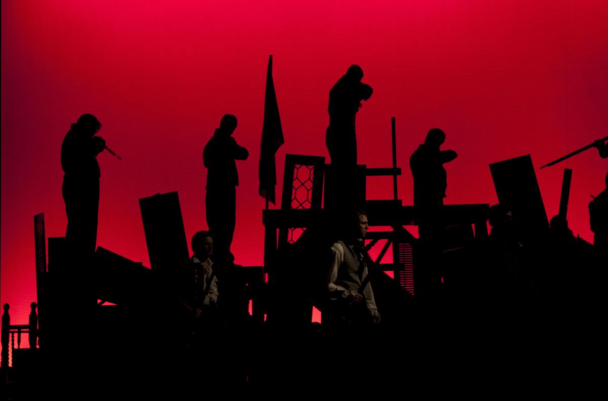 Students performing Les Miserables in front of an audience