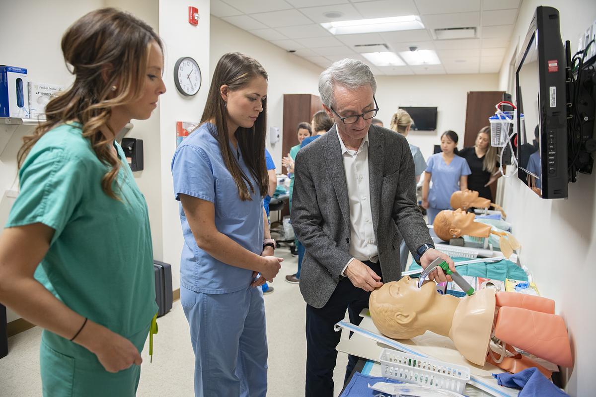 Nursing student looking at a patient
