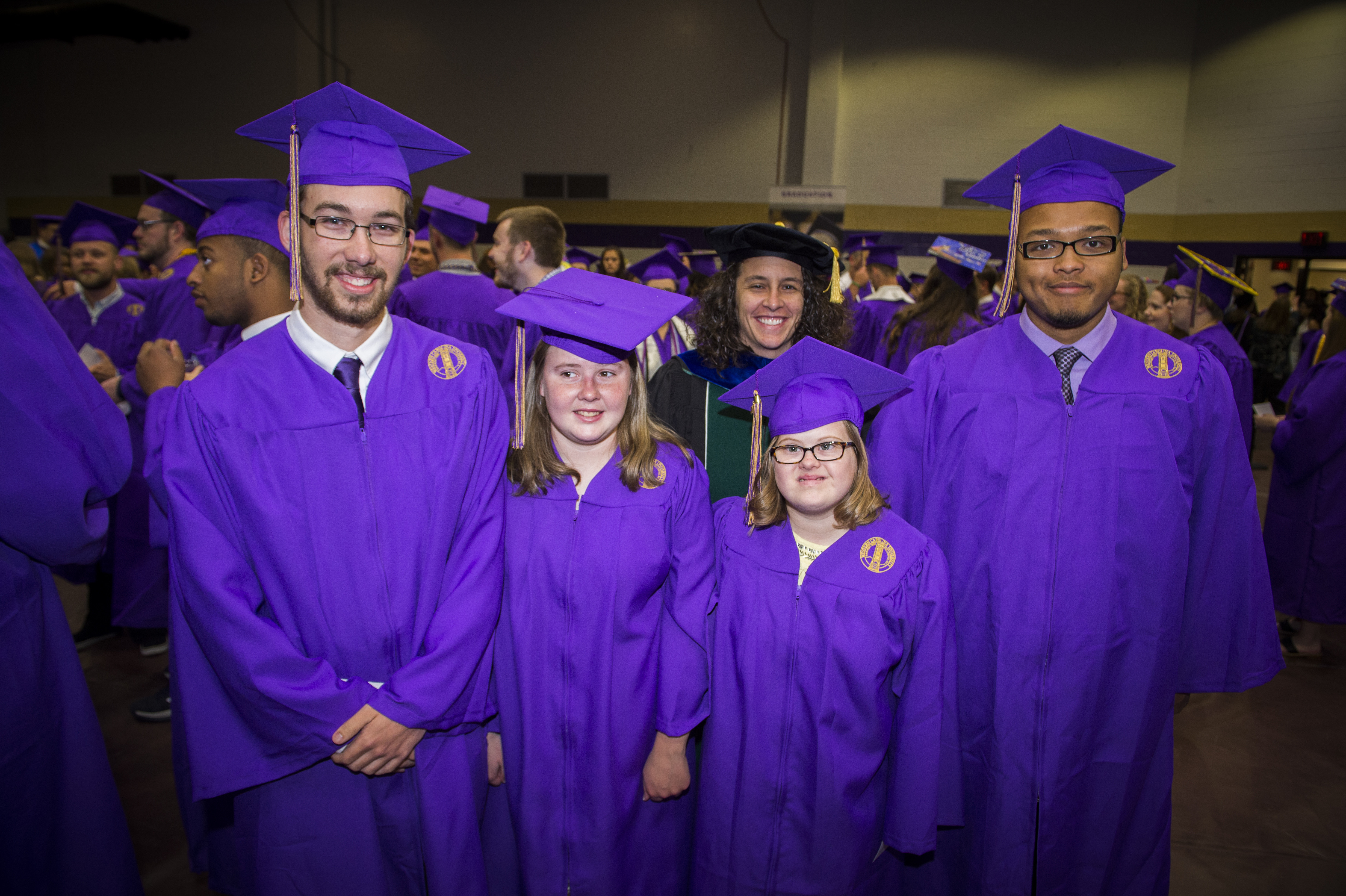 UP program students stand together for a photo at a commencement ceremony