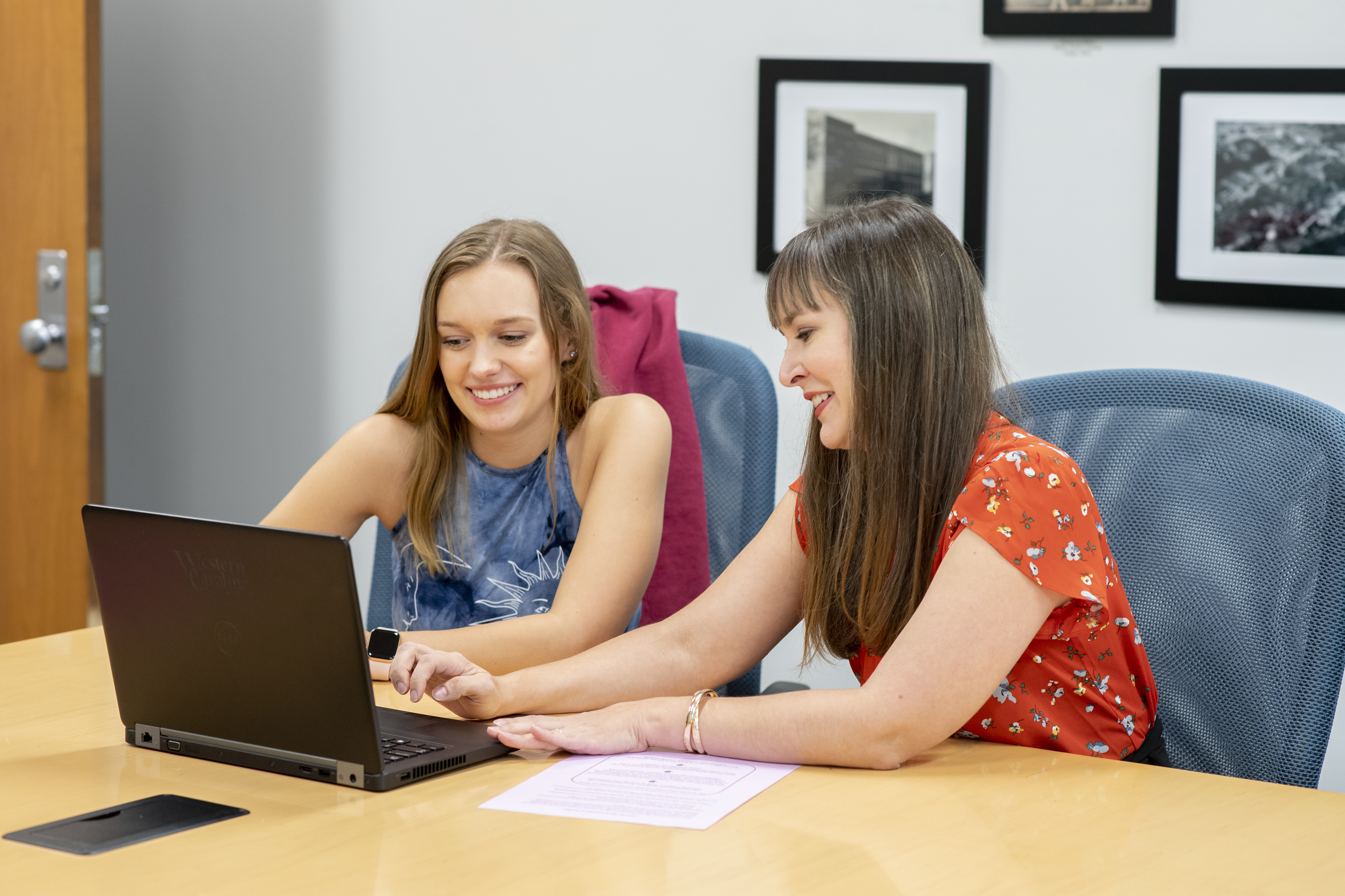 Staff member helping student