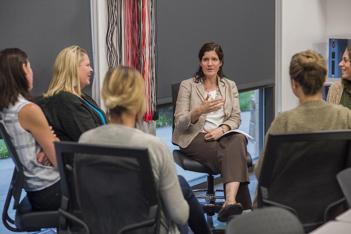 Several individuals sitting in a circle having a conversation