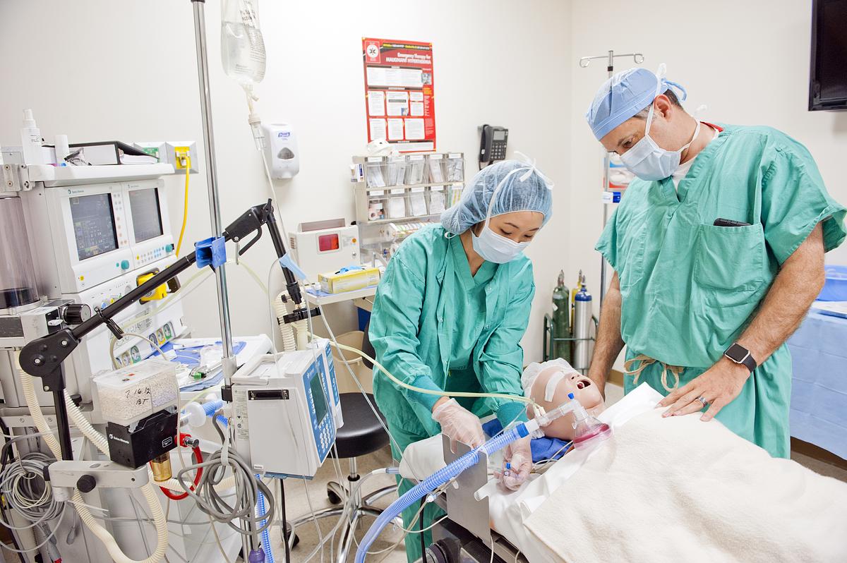 Two nursing students working on a manikin for a medical training session
