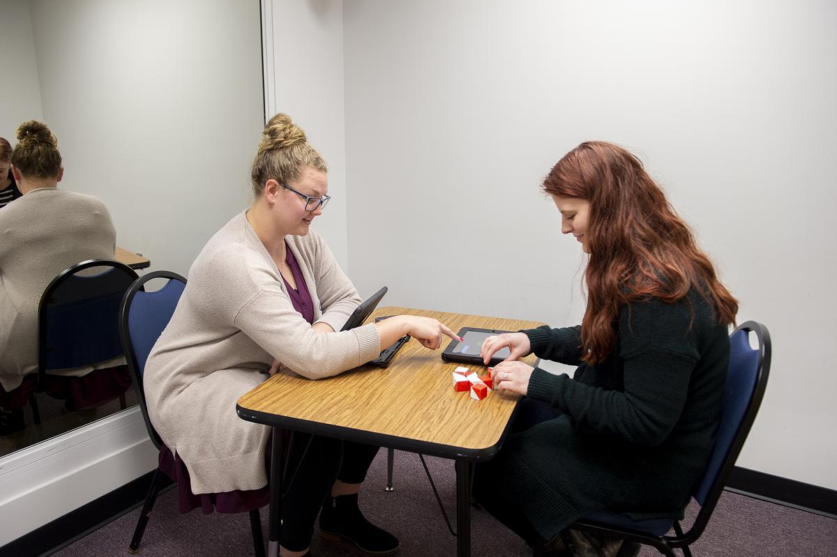 Psychology graduate students working at a desk together