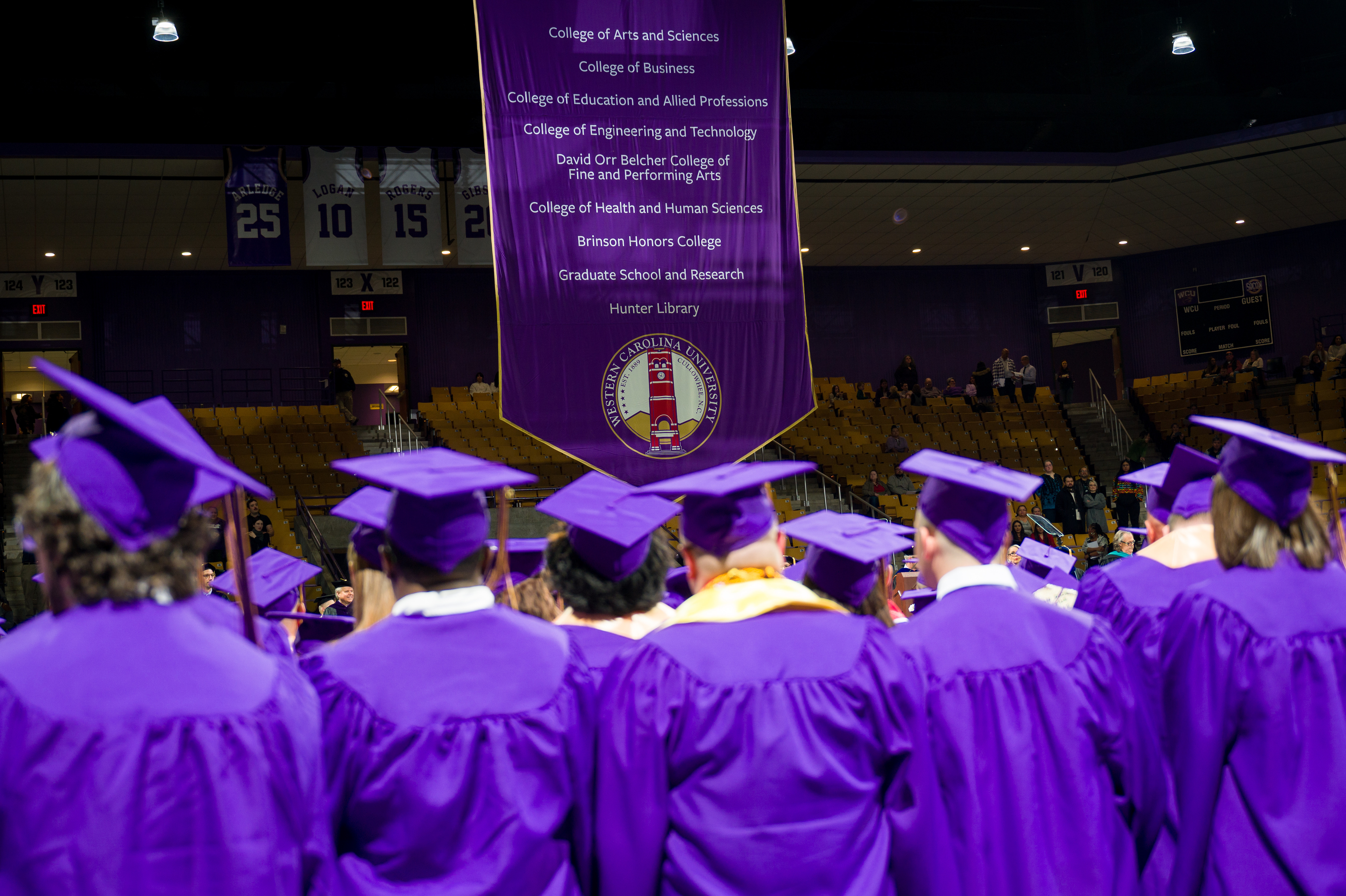 ĢƵstudents at commencement in purple caps and gowns