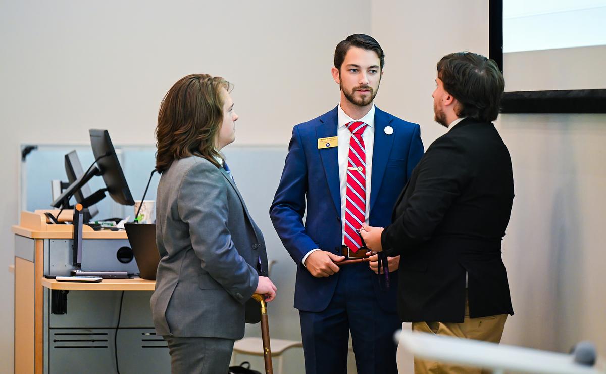 Student legislators in discussion at a podium