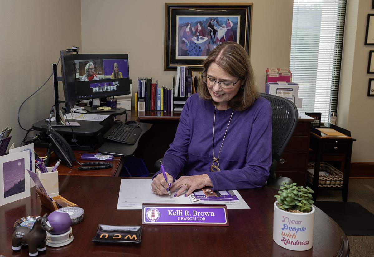 Chancellor Brown signs document