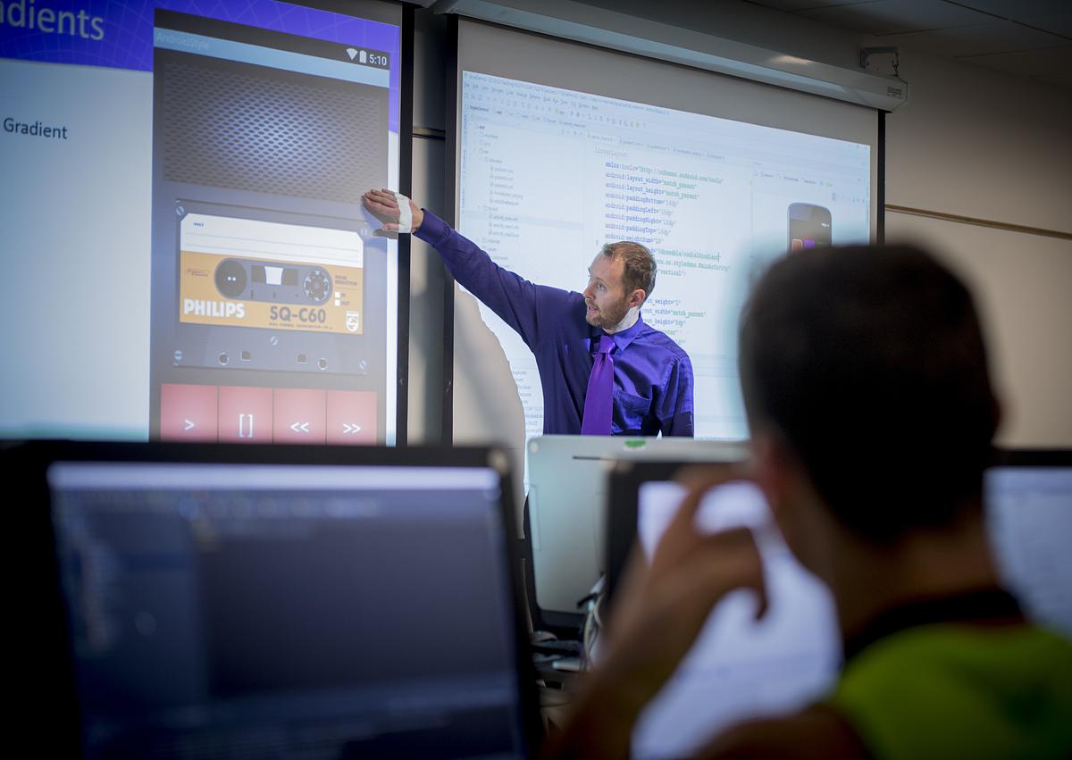Professor shows class a tutorial in a computer science class
