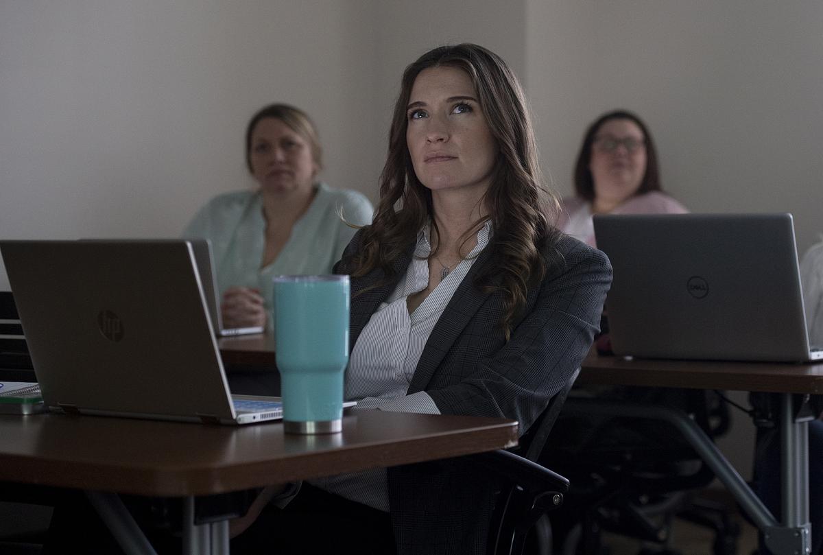 Graduate nursing student listening to a lecture in class