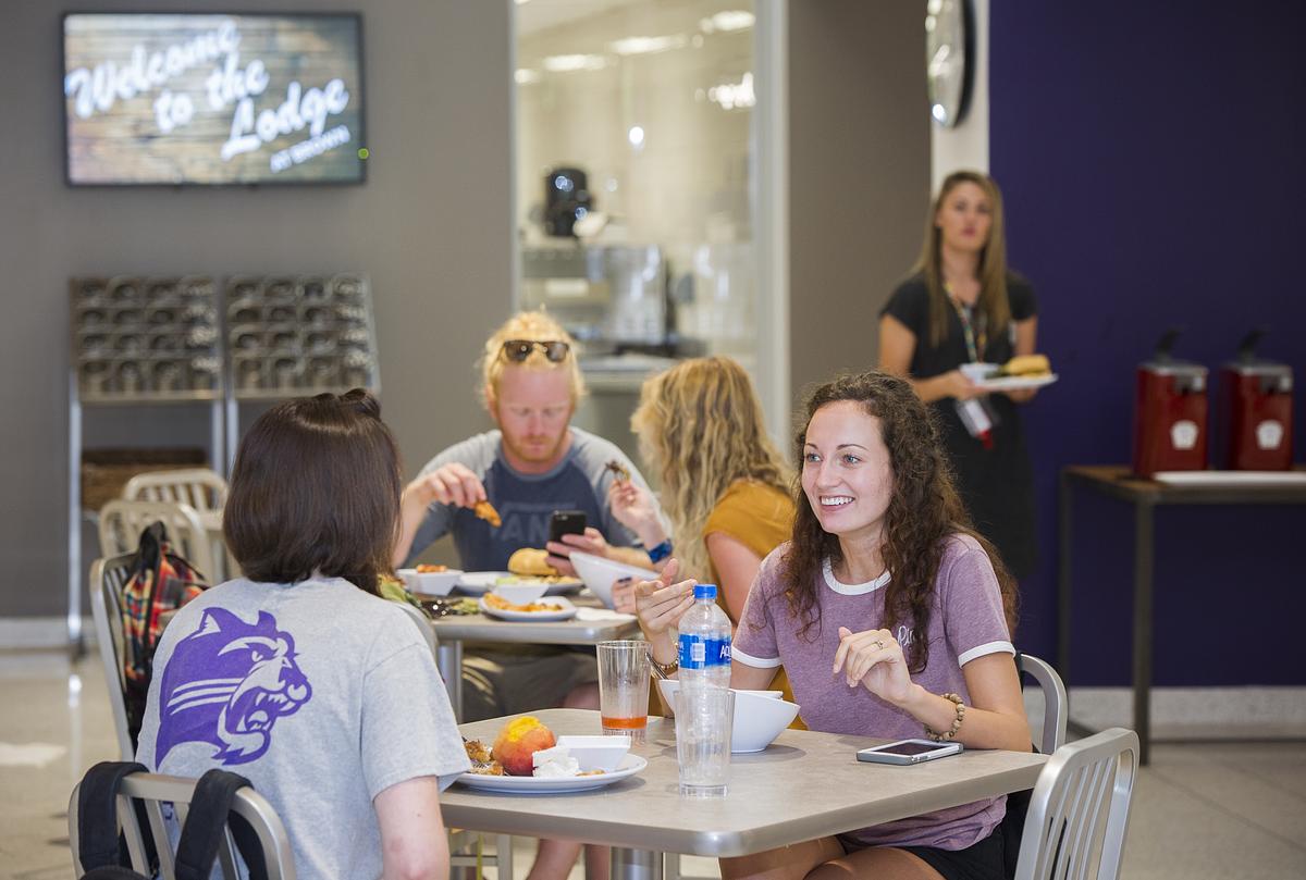 Students dining together at a table in The Lodge