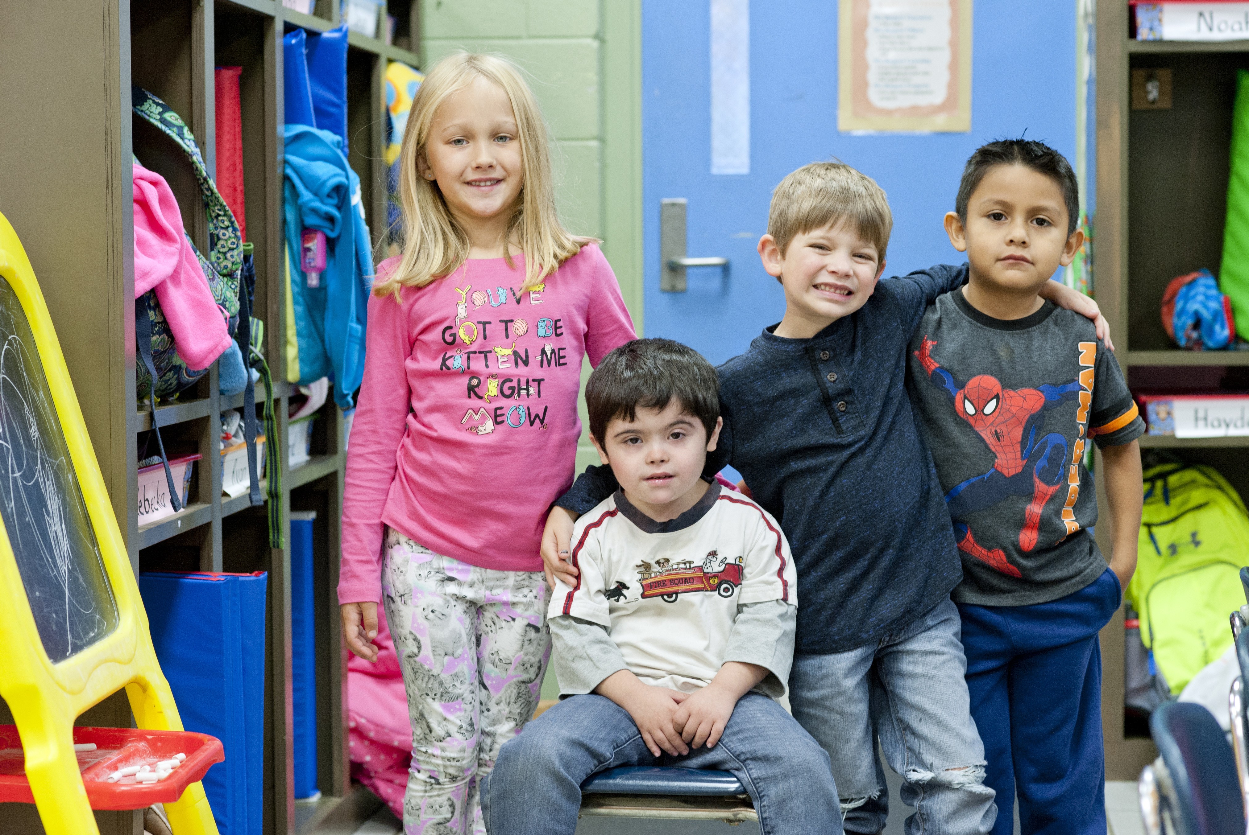 Inclusive education students smiling gathered together for a group photo