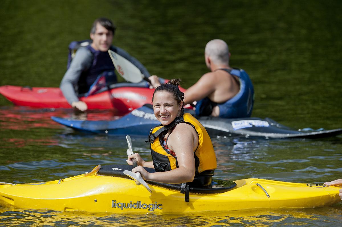 Students enjoying the water in liquidlogic kayaks on a summer day
