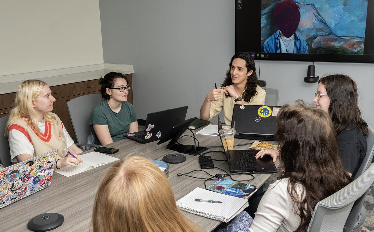 Students sitting around a table in discussion