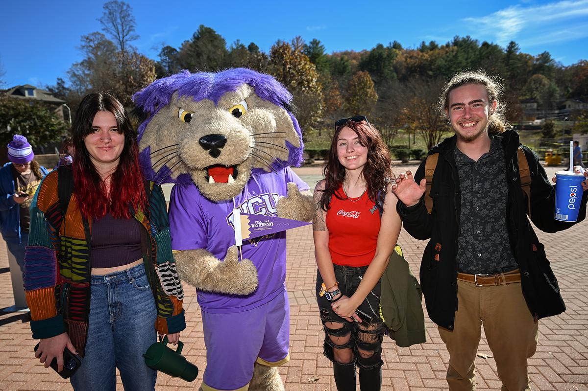 Students and PAWS standing together on campus for a group photo
